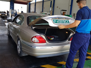 ITV technician inspects temporary "green" import plates on Jaguar X-Type Jaguar X Type with green plates